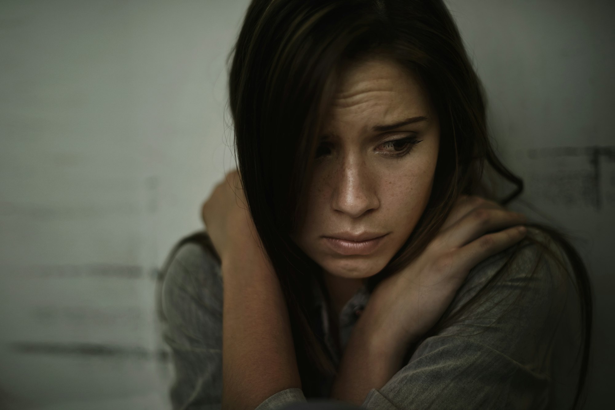 Lost and alone. A young woman looking anxious and fearful.